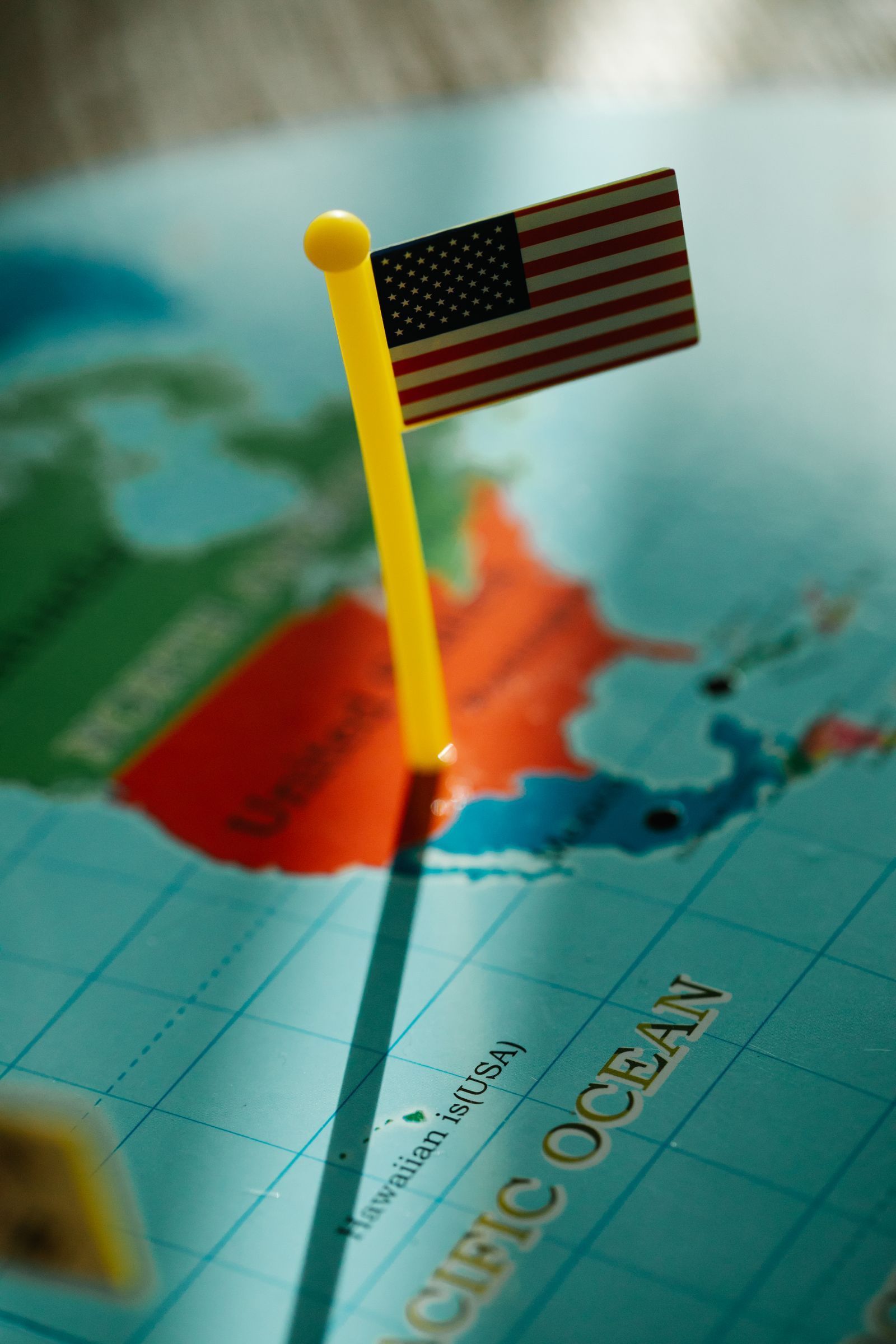 US flag pin on a map of America