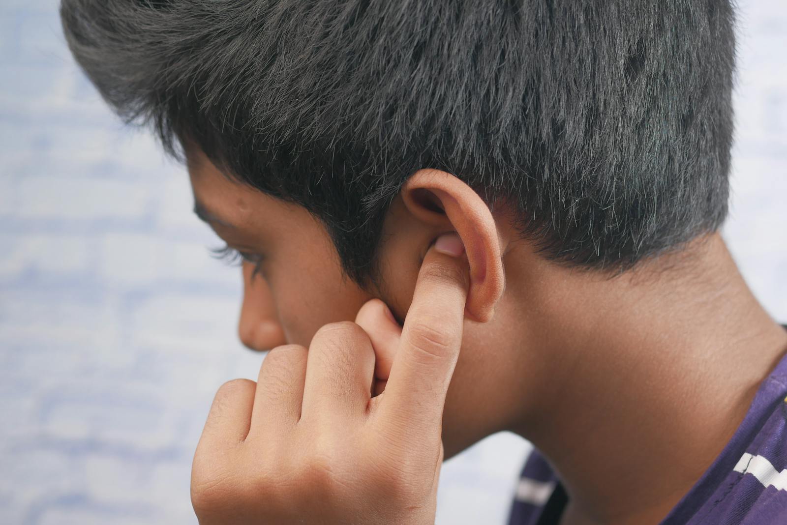 Person covering their ear