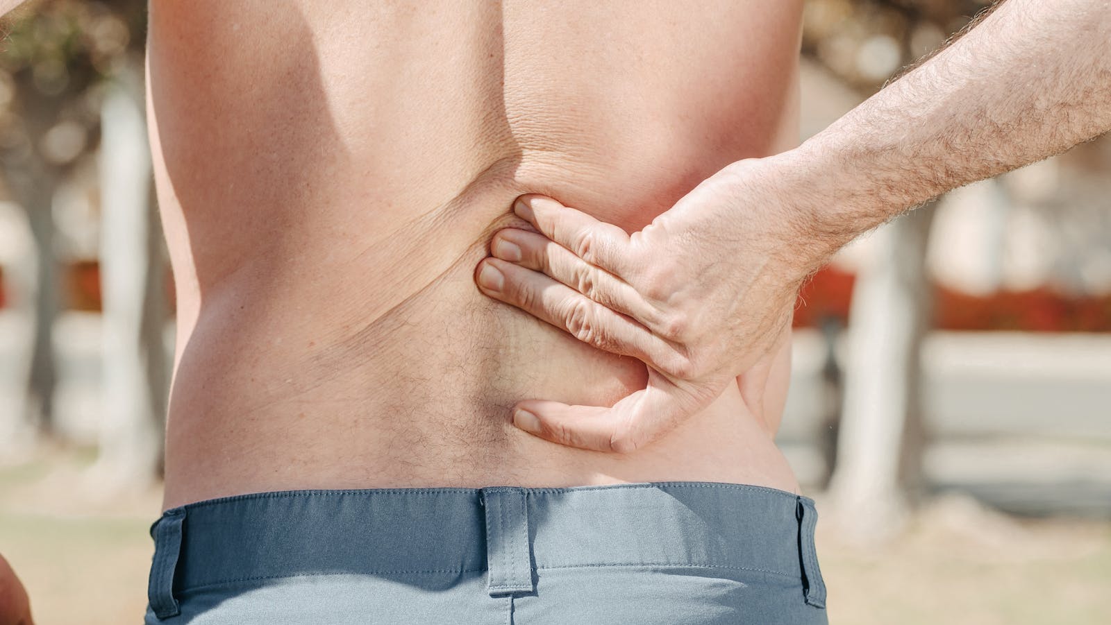 Man holding his lower back