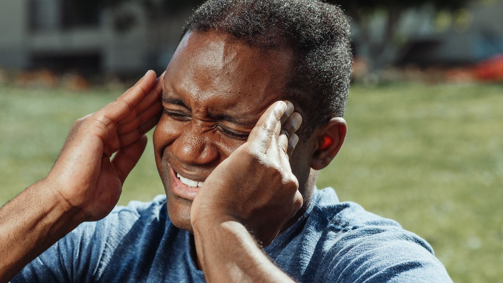 Man holding his head in pain