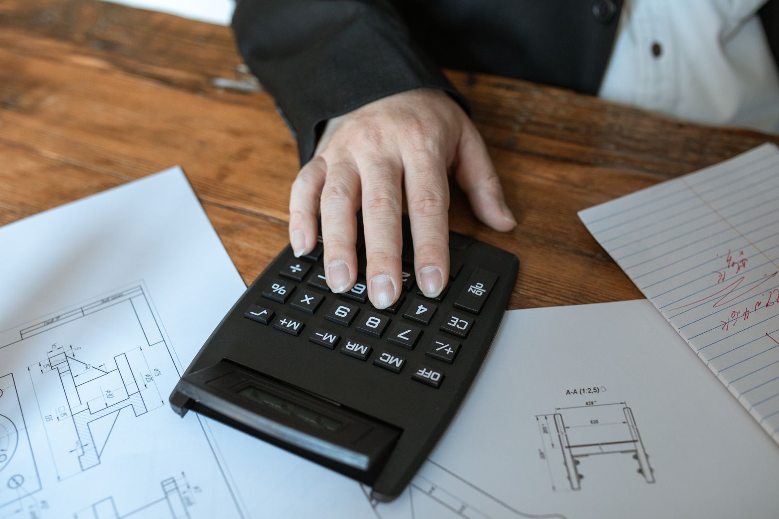 Hands using a calculator