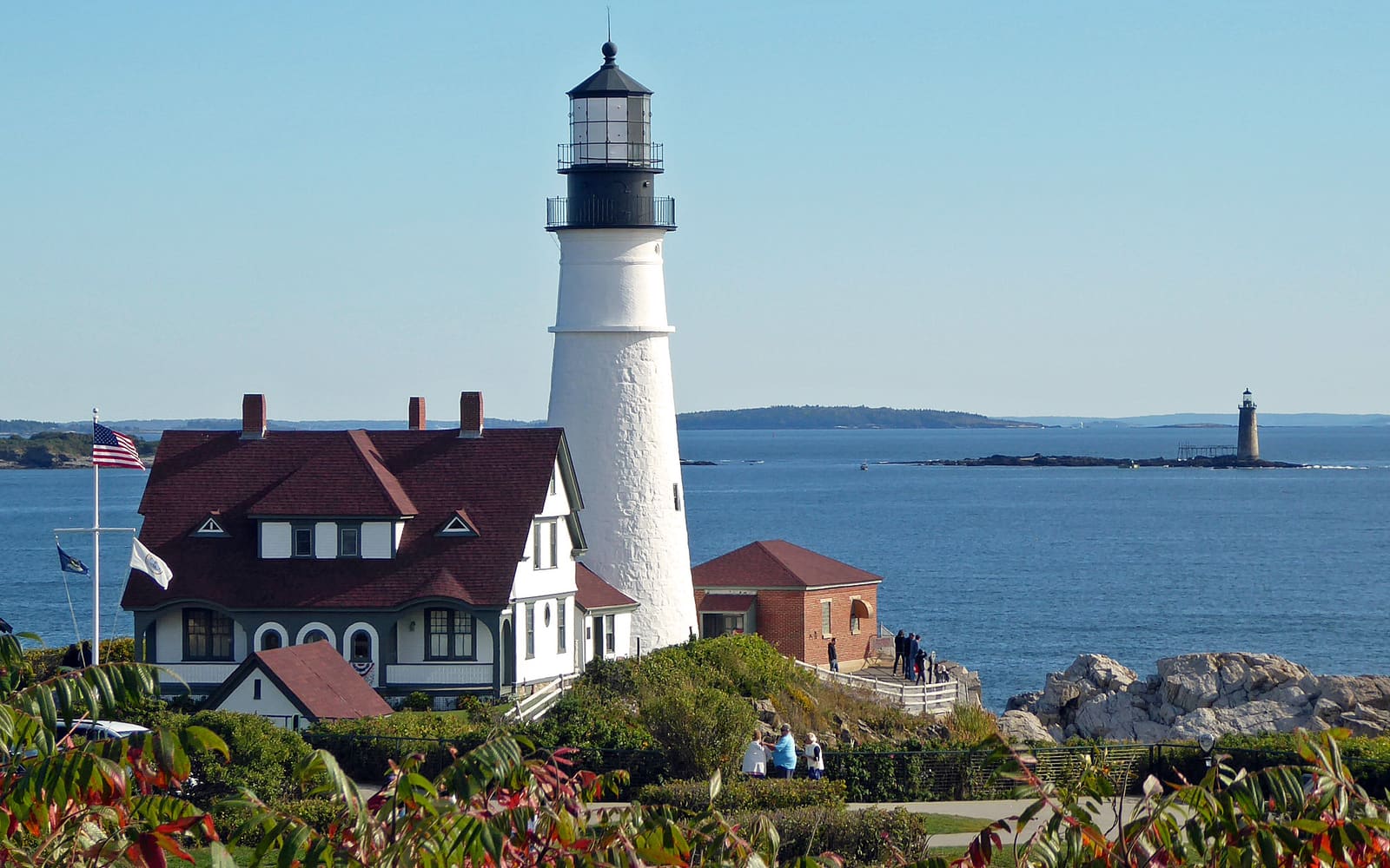 Portland Head Light and its red-roofed keeper’s house on the rocky coast of Cape Elizabeth, Maine
