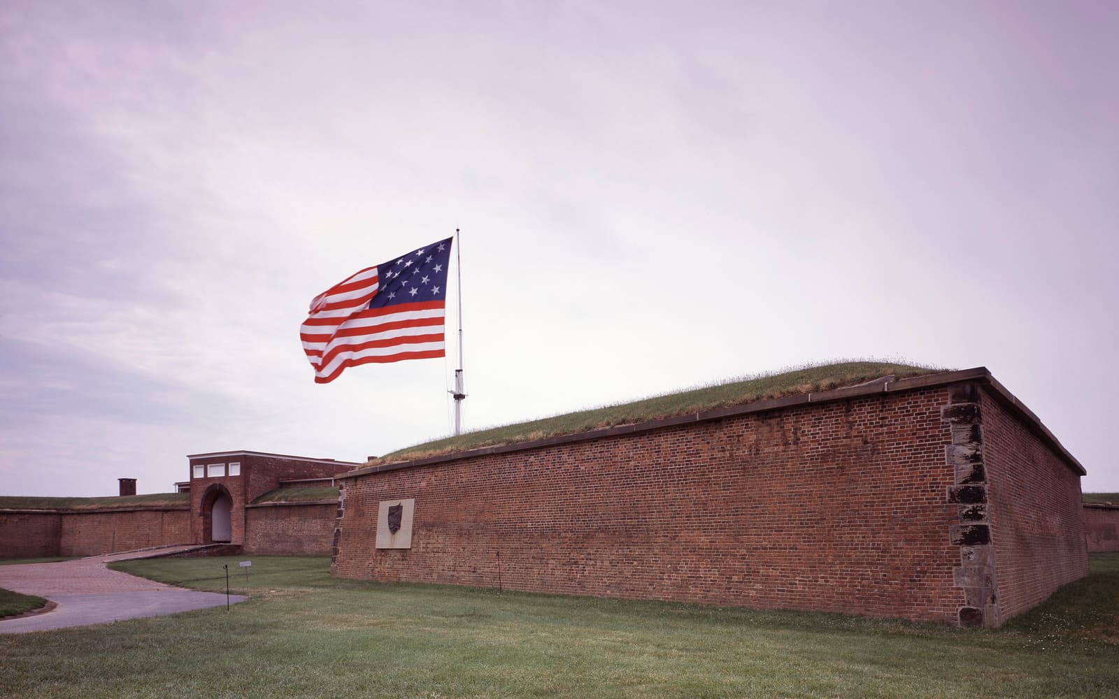 The 15-star flag flying over the brick ramparts of Fort McHenry in Baltimore, Maryland