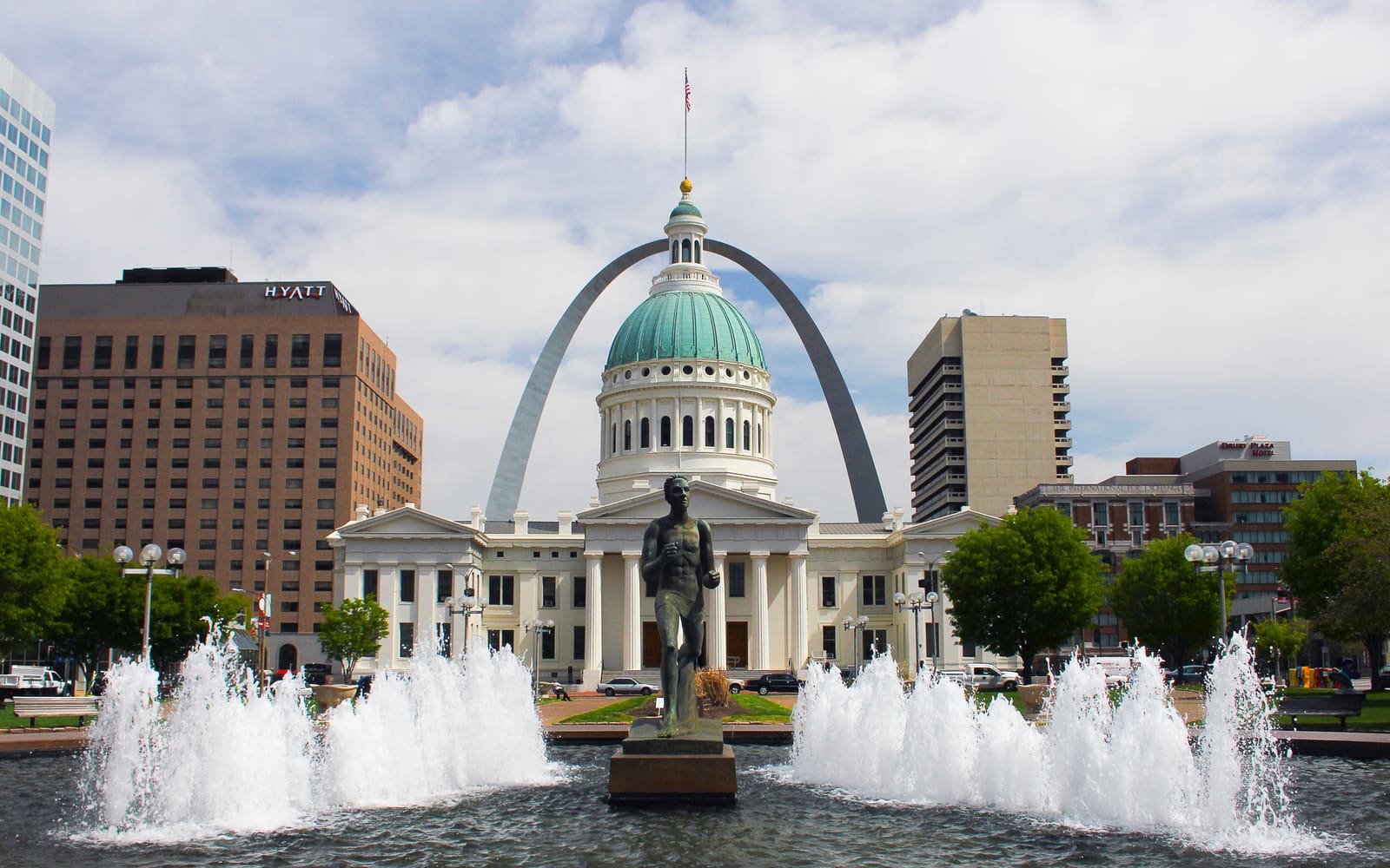 The Gateway Arch rising behind the Old Courthouse dome, seen across the runner fountain in Kiener Plaza, St. Louis