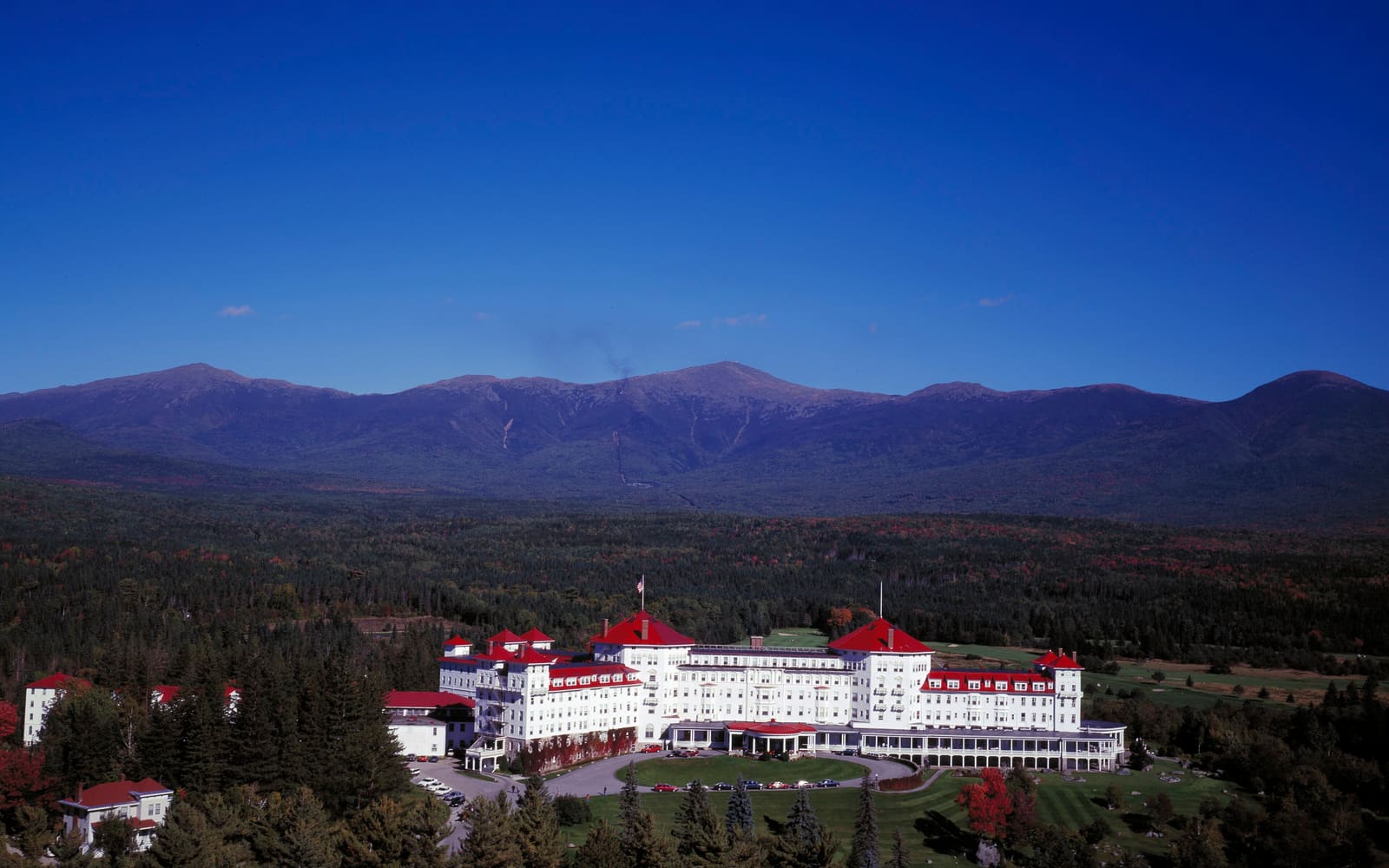 Aerial view of the Mount Washington Hotel at Bretton Woods with the Presidential Range of the White Mountains behind