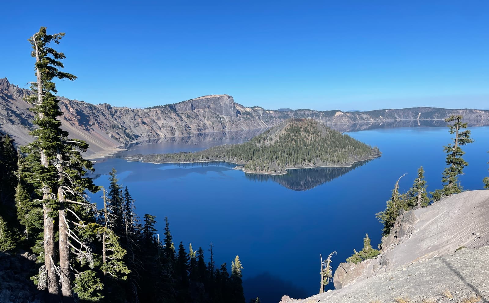 Wizard Island reflected in the deep blue water of Crater Lake, Oregon